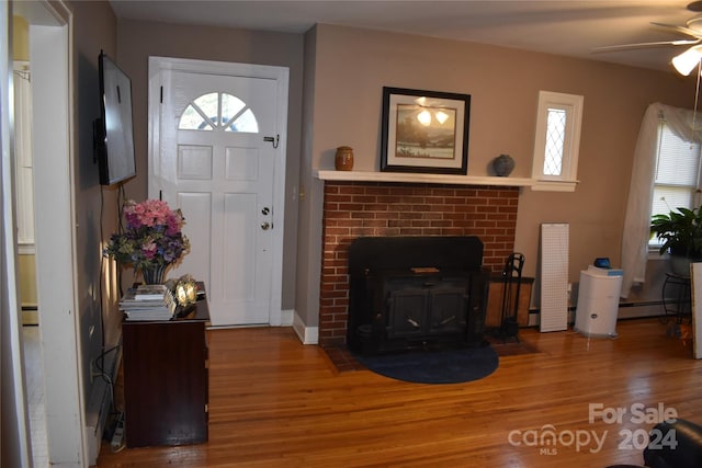 entrance foyer featuring hardwood / wood-style floors, a baseboard heating unit, and ceiling fan