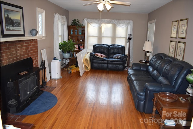 living room with a wealth of natural light, hardwood / wood-style floors, and ceiling fan