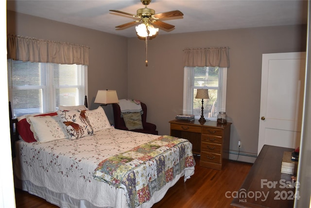 bedroom with baseboard heating, dark hardwood / wood-style flooring, and ceiling fan