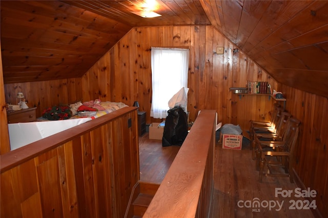 interior space with wood ceiling, wooden walls, vaulted ceiling, and dark hardwood / wood-style flooring