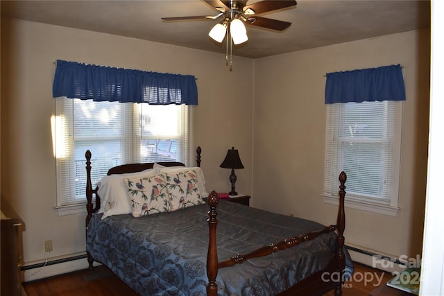 bedroom featuring a baseboard radiator, dark wood-type flooring, and ceiling fan