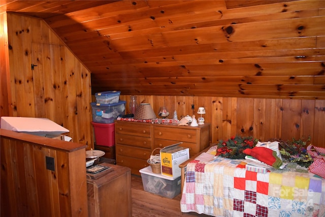 bedroom featuring vaulted ceiling, wood ceiling, hardwood / wood-style flooring, and wood walls