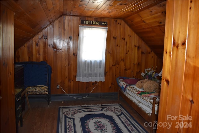 bedroom featuring dark hardwood / wood-style flooring, lofted ceiling, wood walls, and wooden ceiling