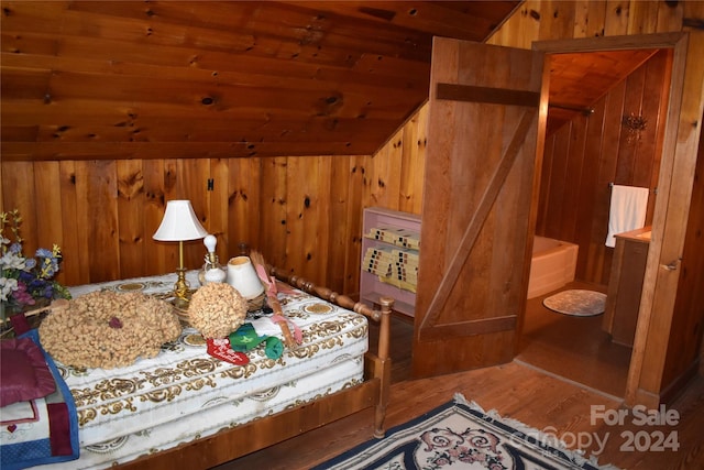 bedroom with wood ceiling, hardwood / wood-style flooring, and wooden walls