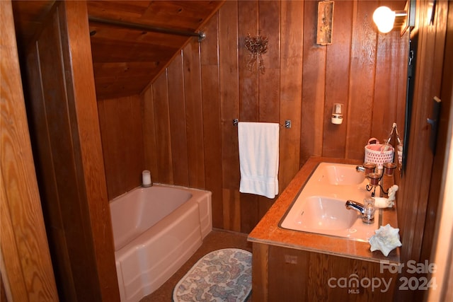 bathroom featuring vanity, wood ceiling, and wood walls