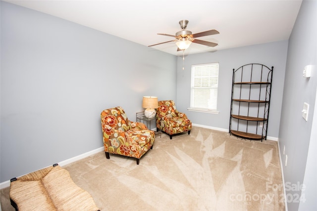 sitting room featuring carpet and ceiling fan