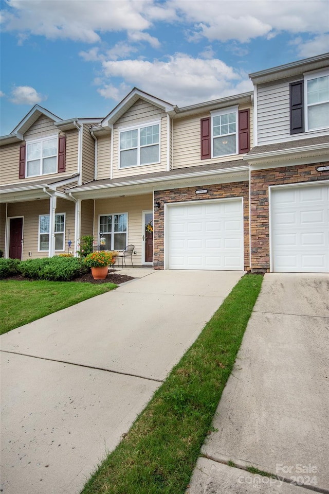 multi unit property featuring a garage