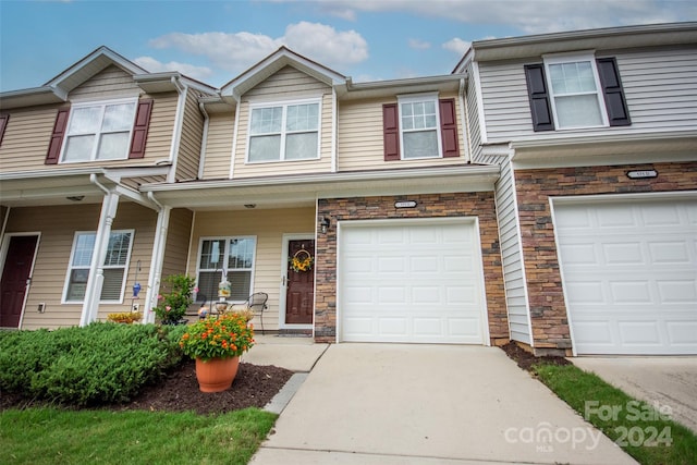 townhome / multi-family property featuring a garage