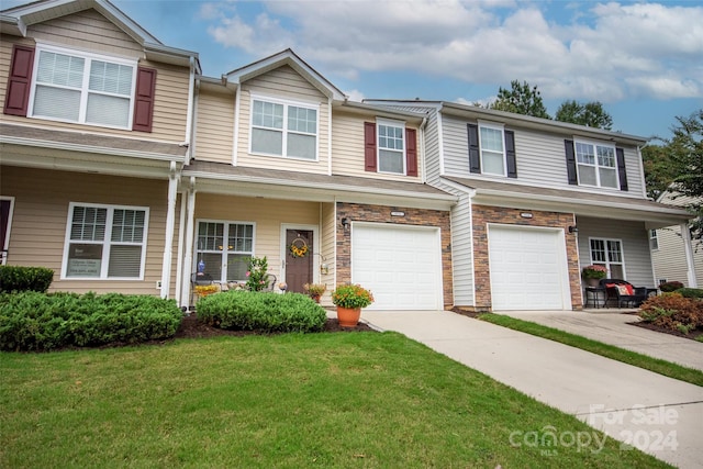 view of property with a garage and a front yard