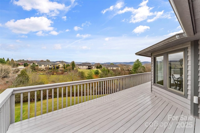 wooden terrace featuring a lawn