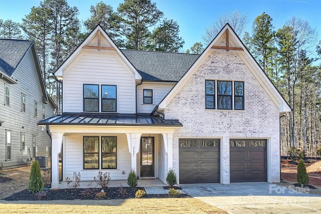 view of front of house with central AC, a porch, and a garage