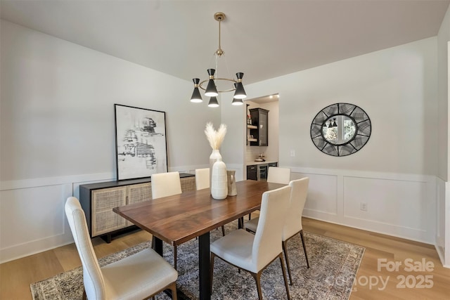 dining room with an inviting chandelier and wood-type flooring