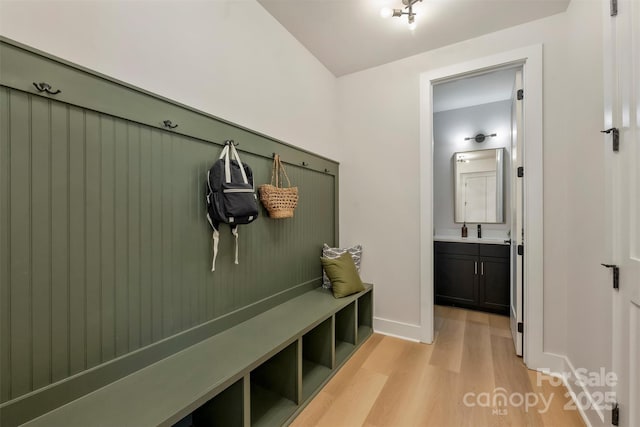 mudroom featuring sink and light hardwood / wood-style flooring