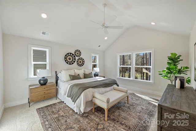 carpeted bedroom with vaulted ceiling and ceiling fan