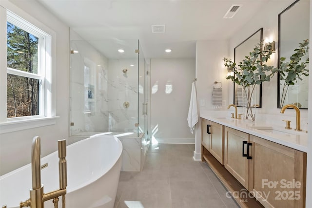 bathroom featuring tile patterned flooring, shower with separate bathtub, and vanity