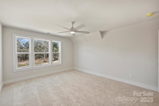 carpeted empty room with lofted ceiling and ceiling fan