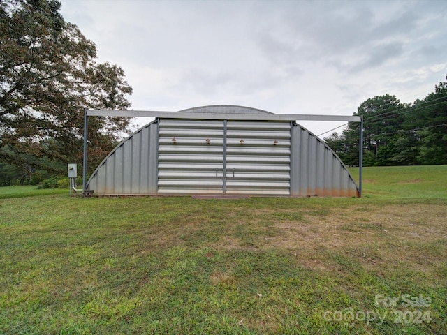 view of outbuilding with a lawn