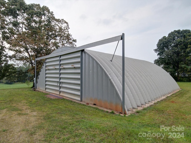 view of outbuilding featuring a yard