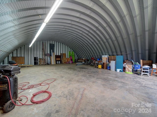 misc room with lofted ceiling and concrete floors