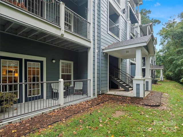 exterior space with a balcony and a yard