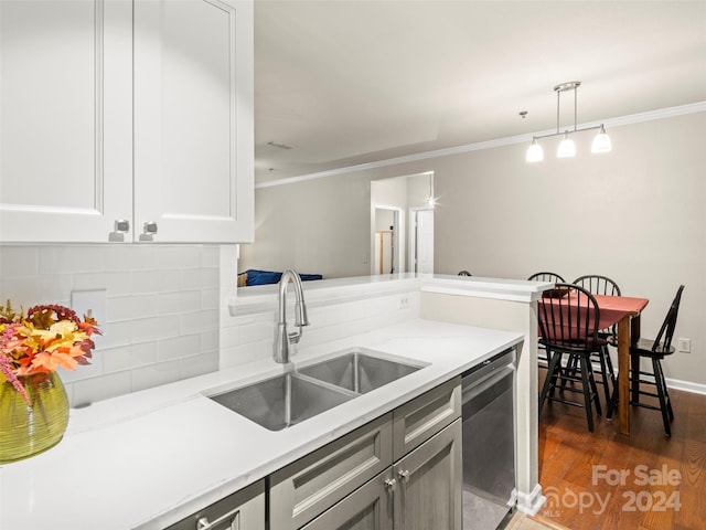 kitchen featuring dark hardwood / wood-style floors, sink, hanging light fixtures, backsplash, and stainless steel dishwasher