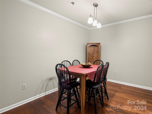 dining room featuring dark hardwood / wood-style floors and crown molding