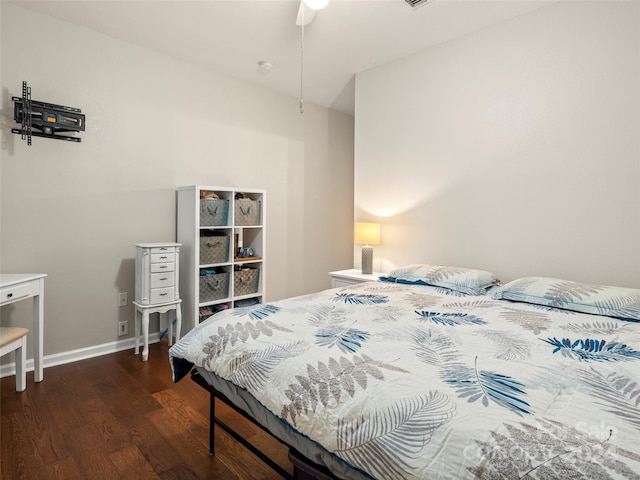 bedroom with dark hardwood / wood-style floors and ceiling fan