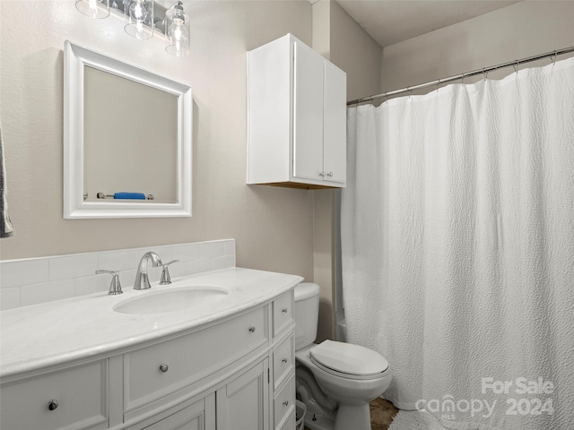 bathroom featuring vanity, toilet, and a shower with shower curtain