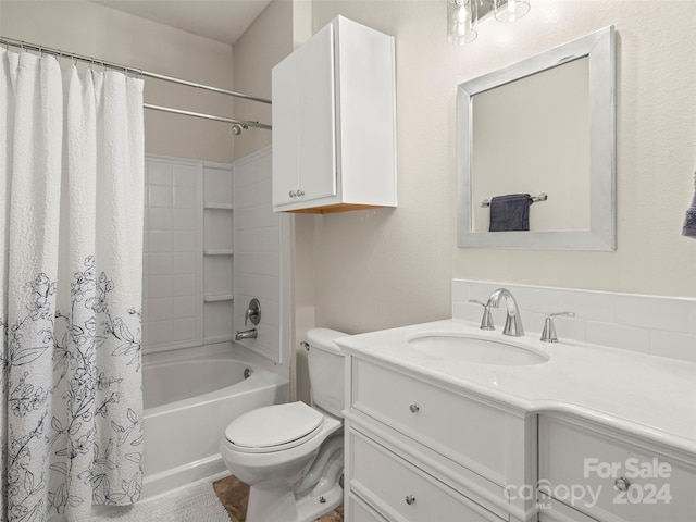 full bathroom featuring shower / bath combo, vanity, and toilet