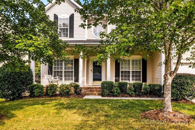 view of front of property featuring a front lawn and a porch