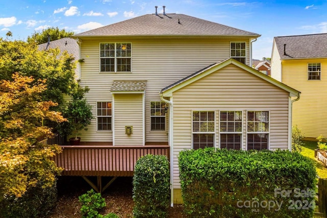 back of house with a wooden deck