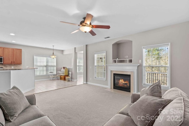 living room featuring light carpet and ceiling fan