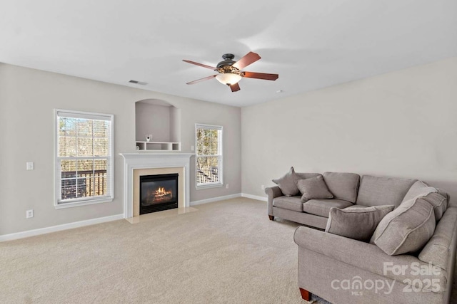 carpeted living room featuring a wealth of natural light and ceiling fan