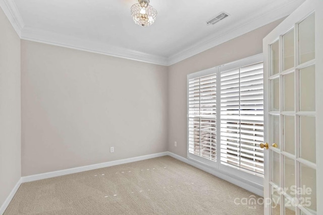 carpeted spare room featuring crown molding