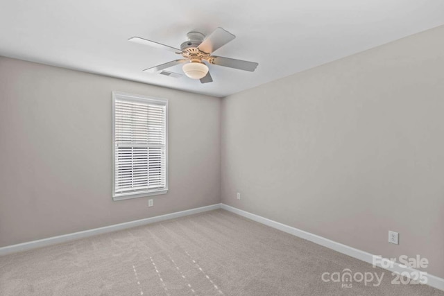 unfurnished room featuring ceiling fan and light carpet