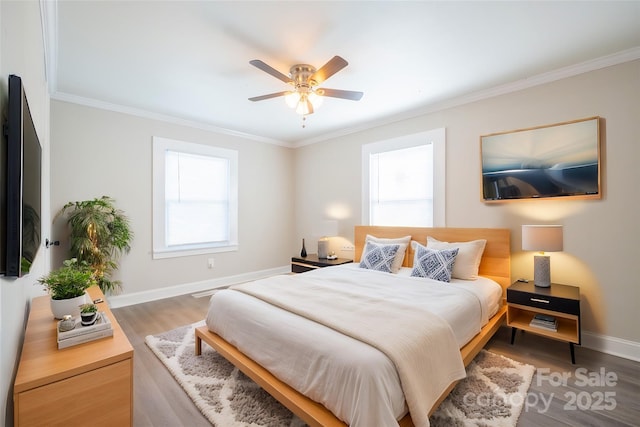 bedroom featuring ceiling fan, ornamental molding, and hardwood / wood-style floors