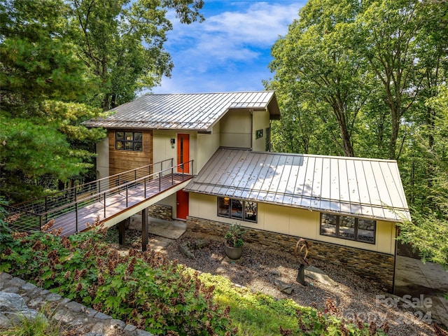 219 Old Toll Rd, Asheville, NC 28804 - rear view of house featuring stairs, metal roof, stone siding, and a standing seam roof