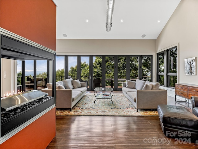 living room with high vaulted ceiling, french doors, and a wealth of natural light