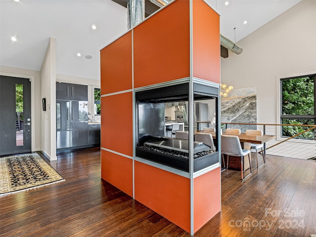 kitchen featuring a high ceiling and dark hardwood / wood-style flooring