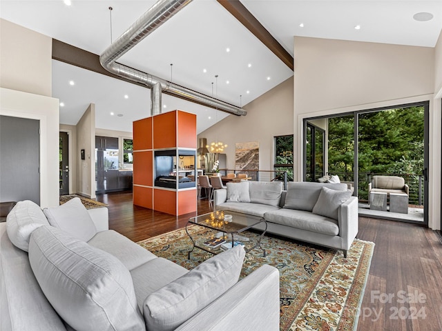 living room with plenty of natural light, dark wood-type flooring, and high vaulted ceiling