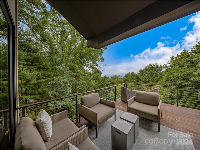 exterior space featuring a balcony and an outdoor hangout area