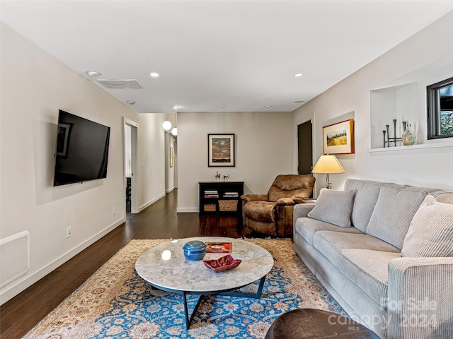 living room with dark hardwood / wood-style flooring