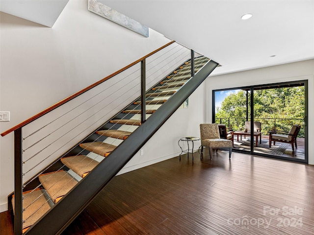 stairs featuring hardwood / wood-style flooring