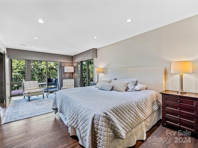 bedroom with access to exterior and hardwood / wood-style floors