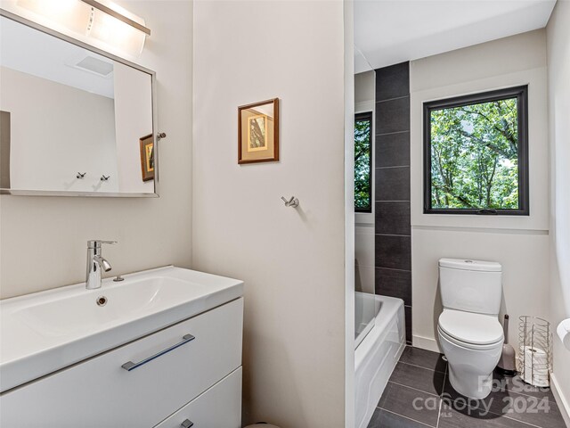 219 Old Toll Rd, Asheville, NC 28804 - full bathroom with toilet, tile patterned floors, baseboards, and vanity