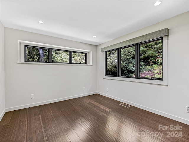 empty room with dark wood-type flooring