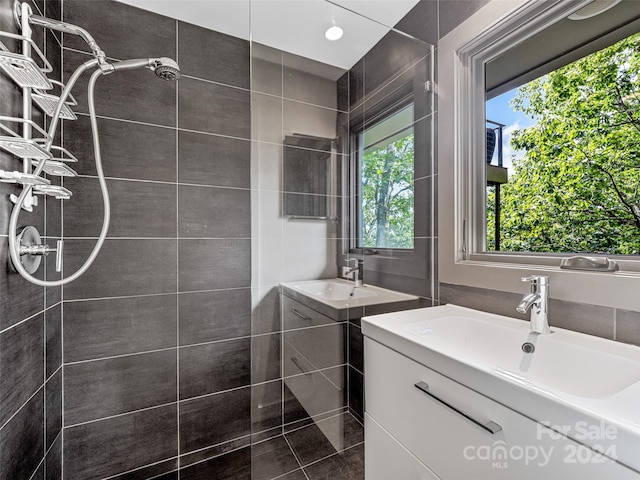 bathroom featuring a tile shower and vanity