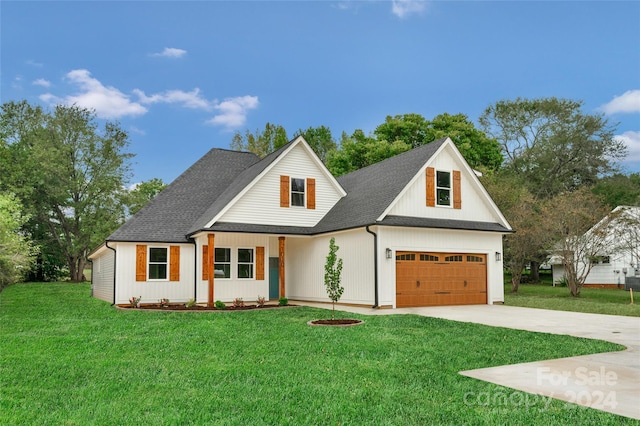 modern inspired farmhouse with a front yard and a garage