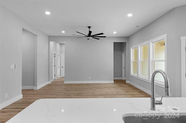 interior space featuring ceiling fan, sink, and light hardwood / wood-style floors