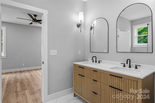 bathroom with wood-type flooring, ceiling fan, and vanity